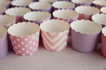 empty cupcake holders in pink and purple designs