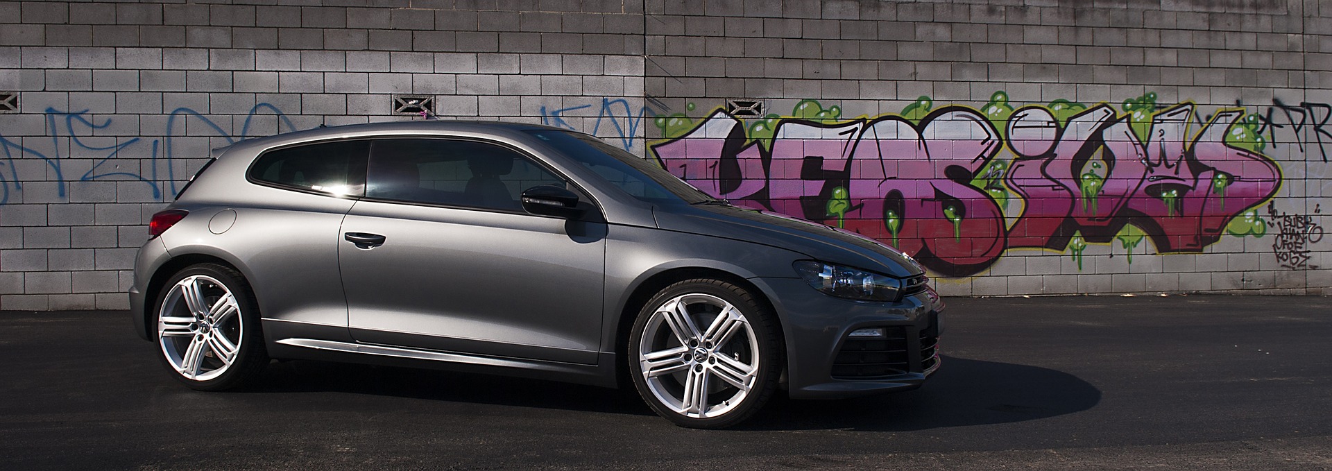 Volkswagen Scirocco against a graffiti background