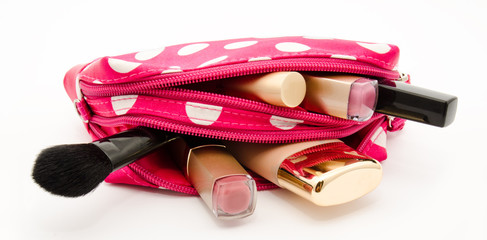 Pink make up bag with cosmetics isolated on a white