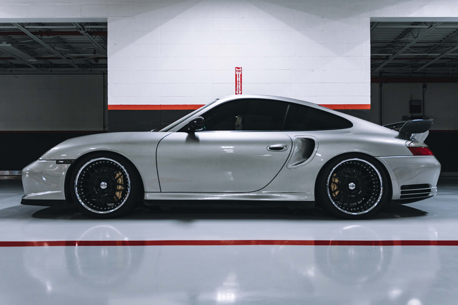 White luxury car on shiny garage floor paint